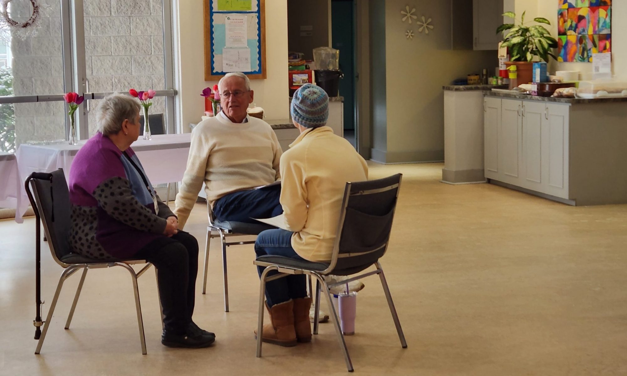 Three people in a small group, talking